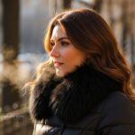 Woman wearing a warm puffer jacket with a faux fur collar during a cold morning.